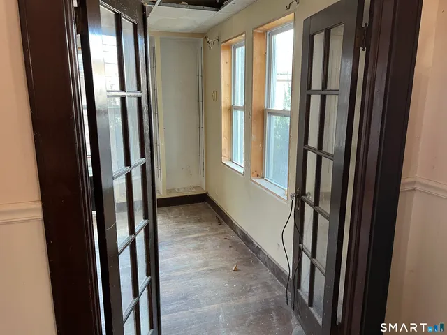 a view of a closet with wooden floor