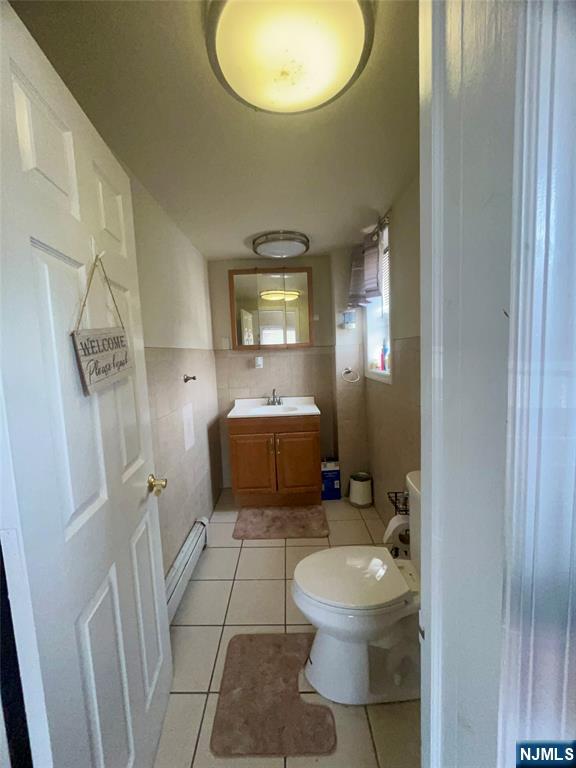 315 Coit Street Irvington, NJ 07111 - Photo 11 of 12 a bathroom with a toilet sink and mirror