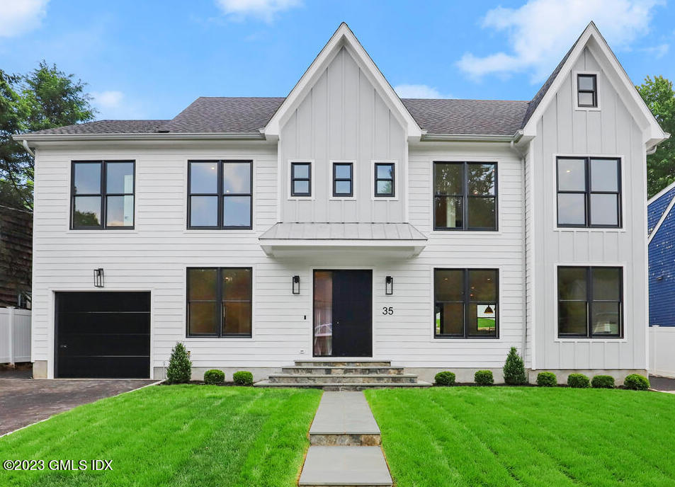 a front view of a house with a yard and garage