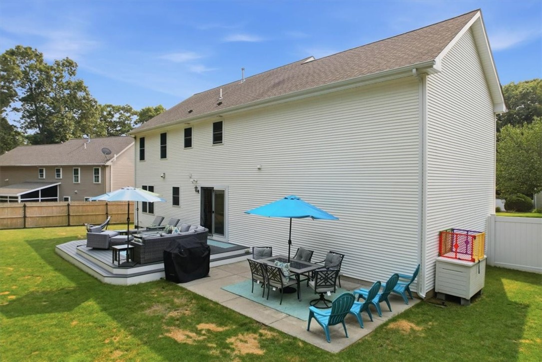 26 Davis Circle Warwick, RI 02886 - Photo 45 of 50 The fully usable backyard features a large composite deck, patio seating area, beautiful lawn, mature landscaping, and storage shed—all designed for effortless entertaining and everyday enjoyment. Whether hosting friends, watching children play, or simply relaxing outdoors, this property offers space to enjoy every season.