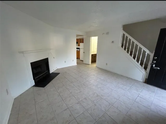 a view of a livingroom with wooden floor and windows