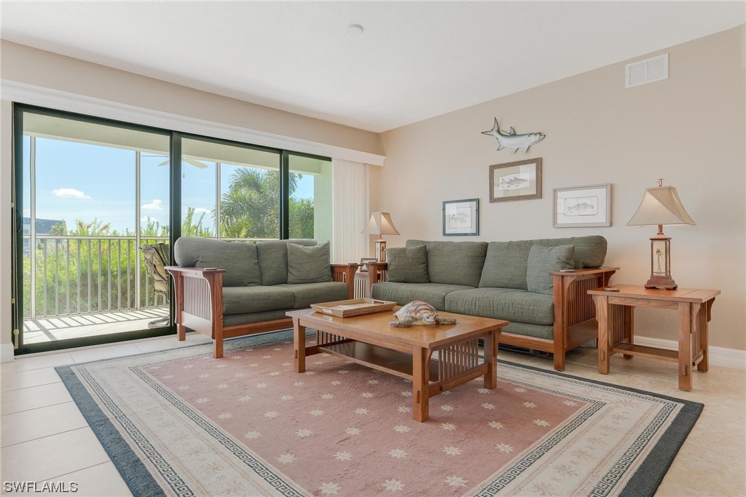 16641 Stringfellow Road, Unit 502 Bokeelia, FL 33922 - Photo 12 of 40 a living room with furniture and a rug