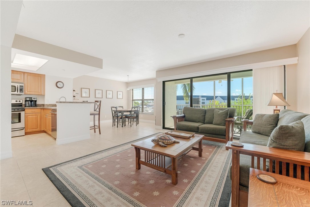 16641 Stringfellow Road, Unit 502 Bokeelia, FL 33922 - Photo 13 of 40 a living room with furniture and a table