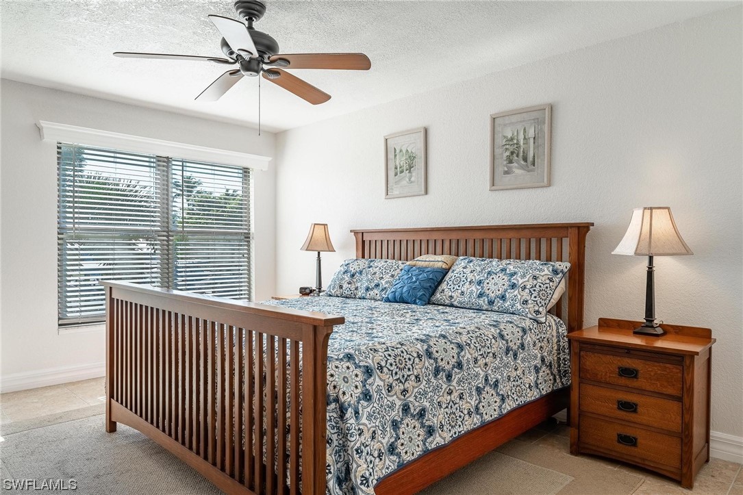 16641 Stringfellow Road, Unit 502 Bokeelia, FL 33922 - Photo 14 of 40 a bedroom with a bed and a window