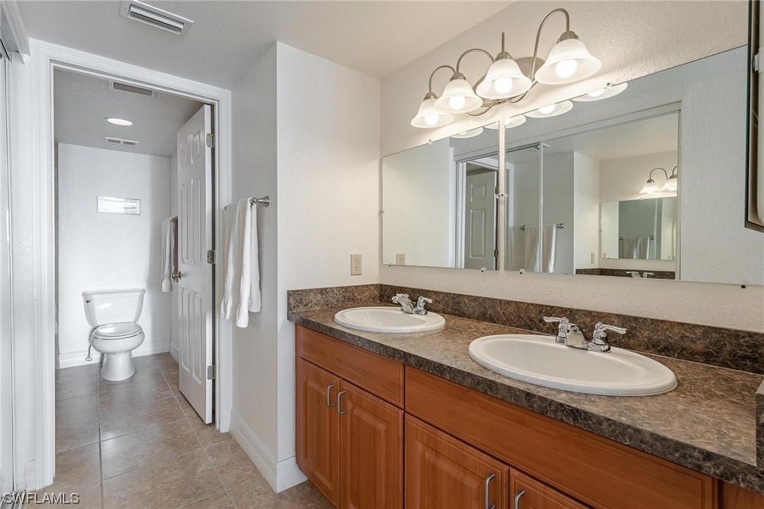 16641 Stringfellow Road, Unit 502 Bokeelia, FL 33922 - Photo 16 of 40 a bathroom with a granite countertop sink and a mirror