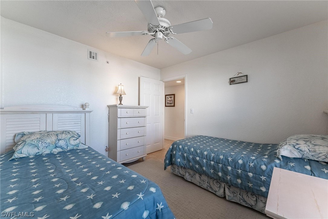16641 Stringfellow Road, Unit 502 Bokeelia, FL 33922 - Photo 18 of 40 a bedroom with a bed and a chandelier