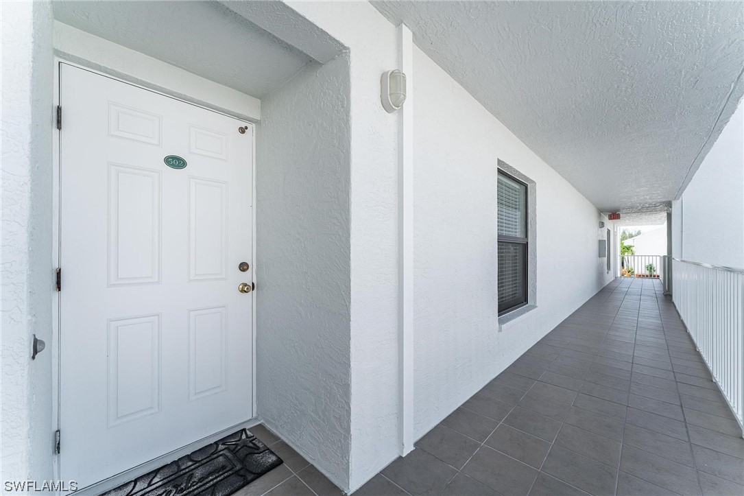 16641 Stringfellow Road, Unit 502 Bokeelia, FL 33922 - Photo 2 of 40 a view of a hallway with wooden floor