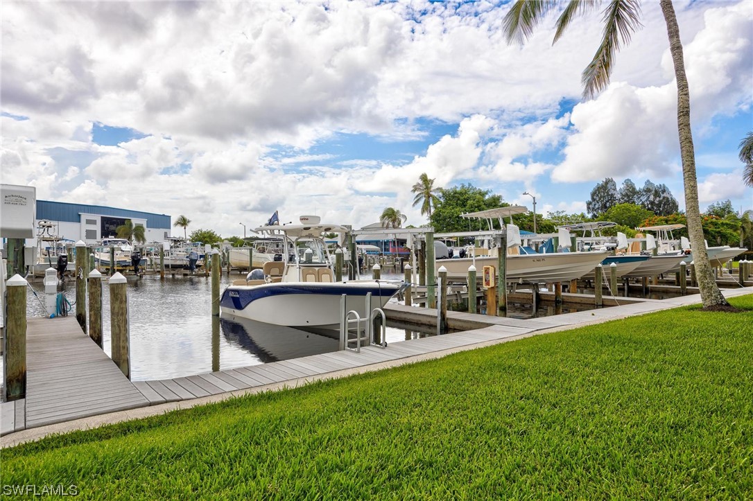 16641 Stringfellow Road, Unit 502 Bokeelia, FL 33922 - Photo 28 of 40 a view of a swimming pool with lawn chairs and a big yard