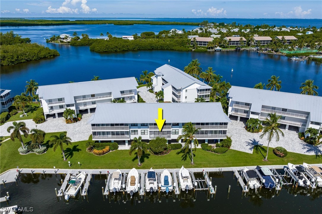 16641 Stringfellow Road, Unit 502 Bokeelia, FL 33922 - Photo 29 of 40 an aerial view of residential houses with outdoor space and lake view