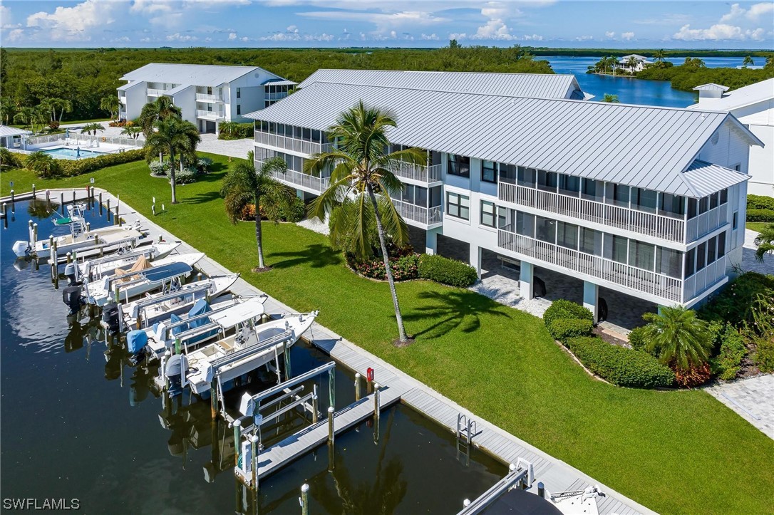 16641 Stringfellow Road, Unit 502 Bokeelia, FL 33922 - Photo 32 of 40 aerial view of a house with a garden and lake view