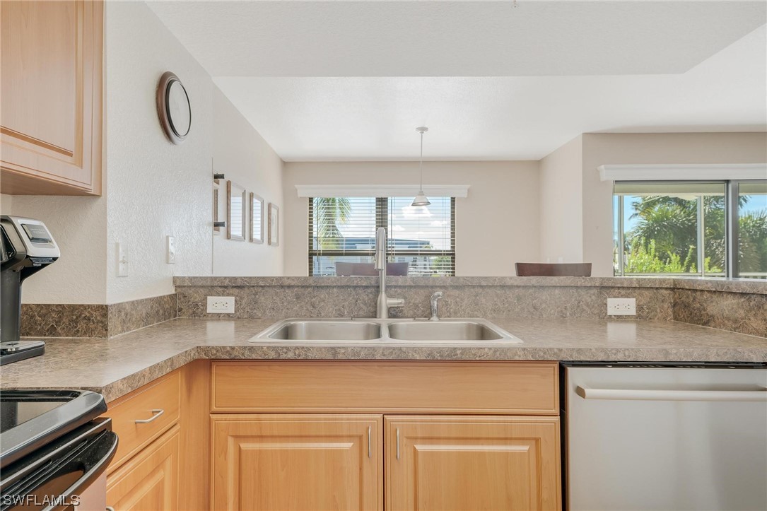16641 Stringfellow Road, Unit 502 Bokeelia, FL 33922 - Photo 6 of 40 a kitchen with granite countertop a sink and a window