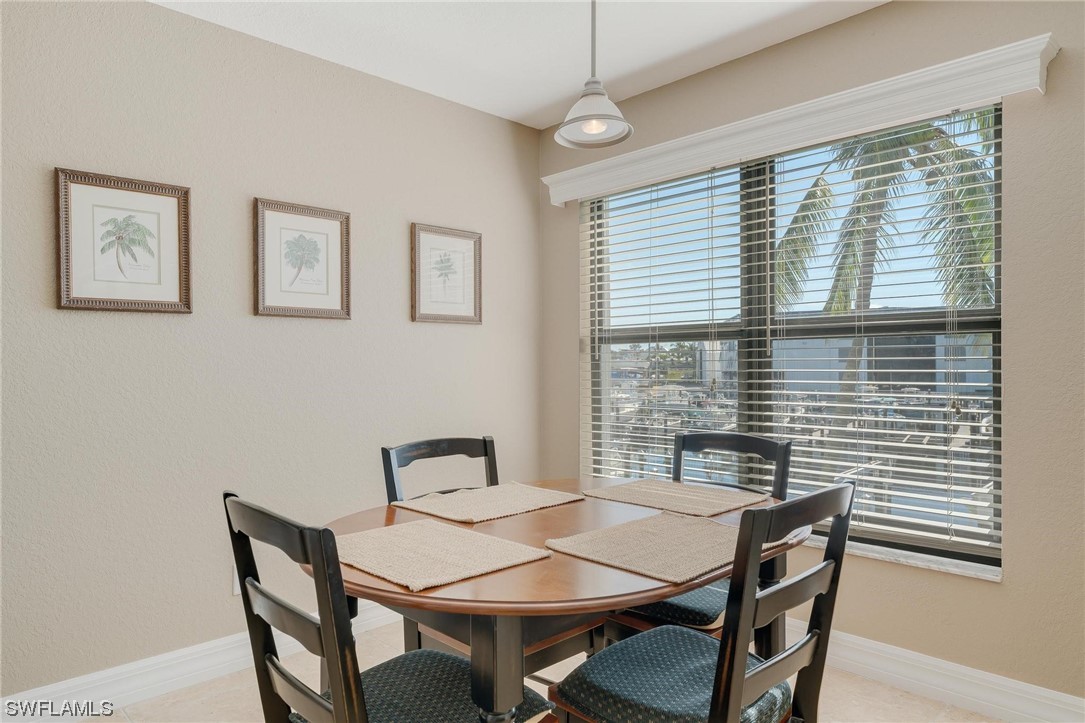16641 Stringfellow Road, Unit 502 Bokeelia, FL 33922 - Photo 9 of 40 a view of a dining room with furniture and window