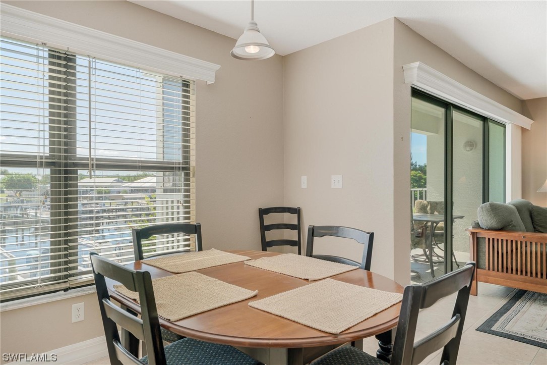 16641 Stringfellow Road, Unit 502 Bokeelia, FL 33922 - Photo 10 of 40 a view of a dining room with furniture and window
