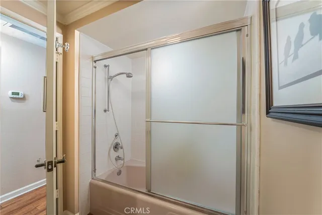 a bedroom with a bed and a large mirror