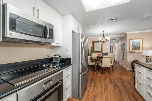 a kitchen with stainless steel appliances a refrigerator sink and microwave