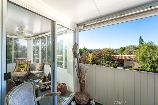 a dining room with wooden floor a chandelier a wooden table and chairs