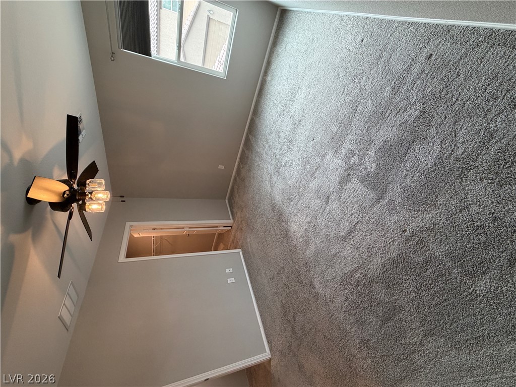 916 Riggs Flats Avenue North Las Vegas, NV 89086 - Photo 21 of 43 Soft plush carpeting pairs with neutral walls and ample natural light in this bedroom.