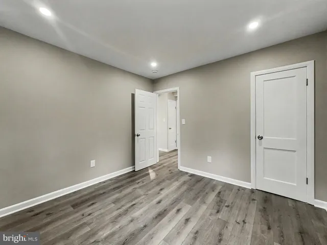 a view of hallway with wooden floor