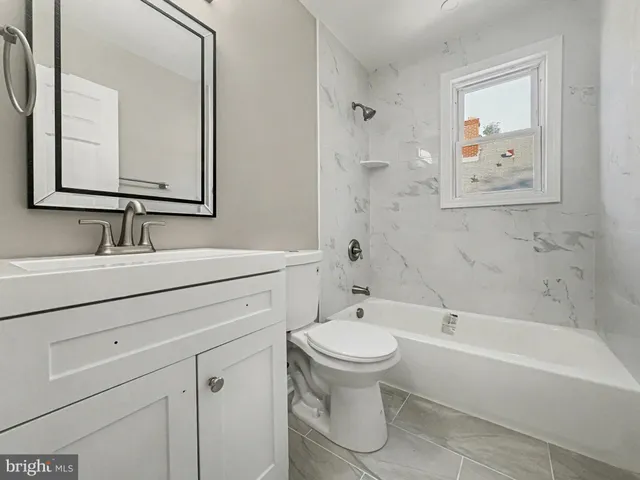 a bathroom with a sink toilet and bathtub