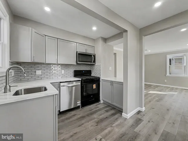a kitchen with a sink stove and refrigerator