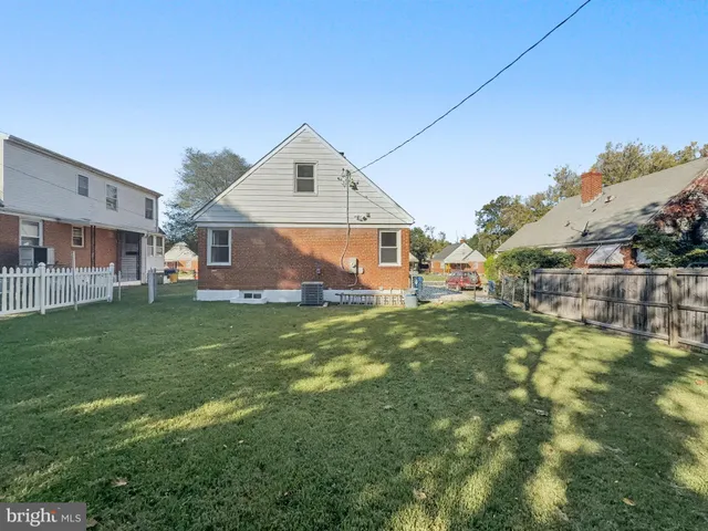a front view of a house with a yard table and chairs