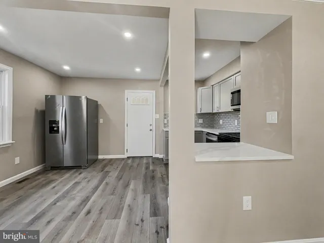 a view of a refrigerator in kitchen and wooden floor