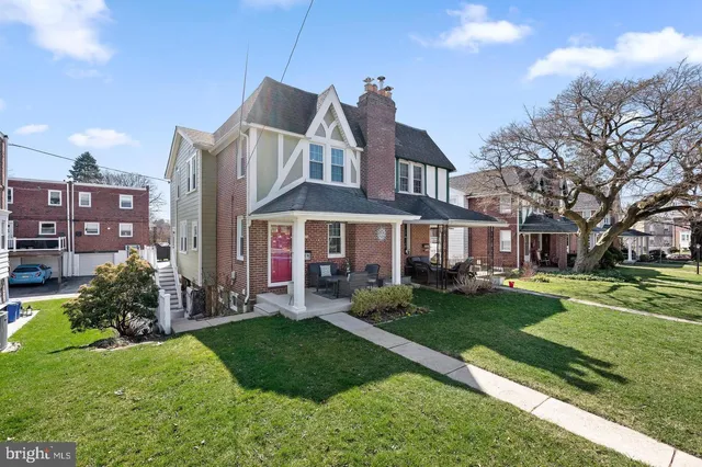 a front view of a house with a yard table and chairs