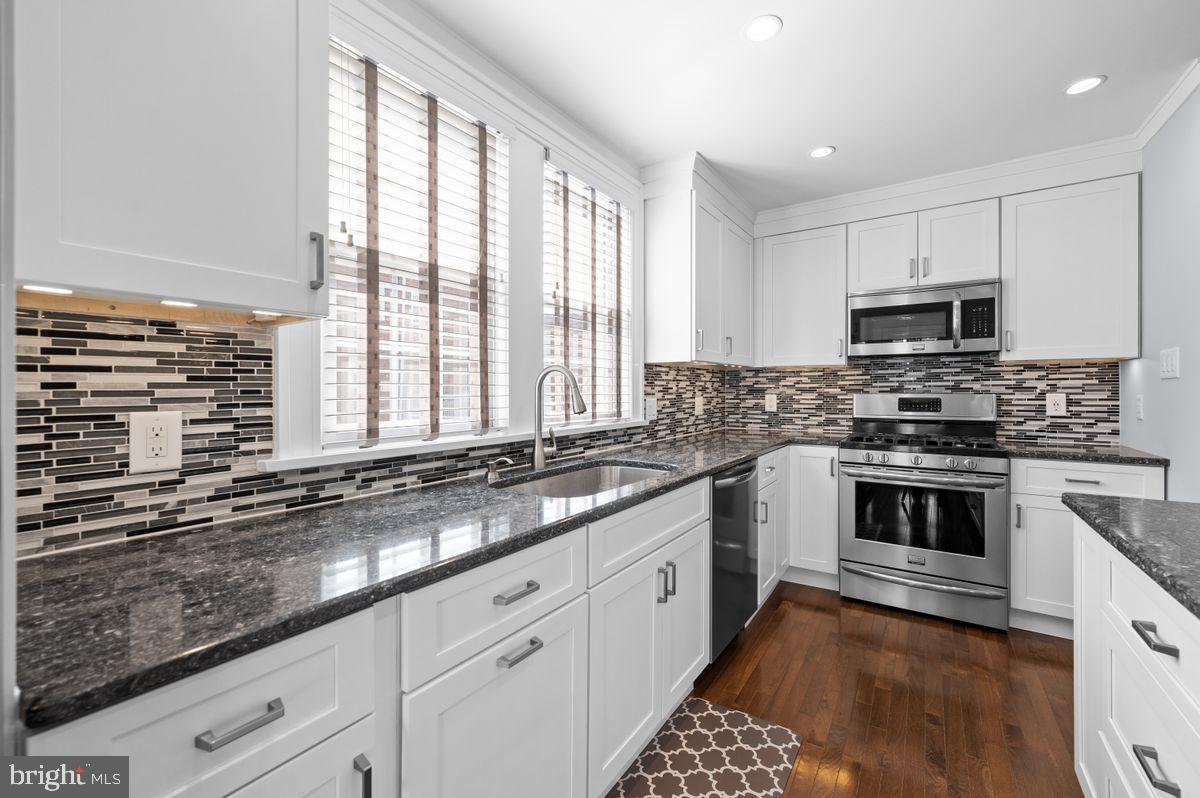 627 Kenilworth Road Ardmore, PA 19003 - Photo 2 of 11 a kitchen with stainless steel appliances kitchen island granite countertop a sink a stove a counter space and cabinets