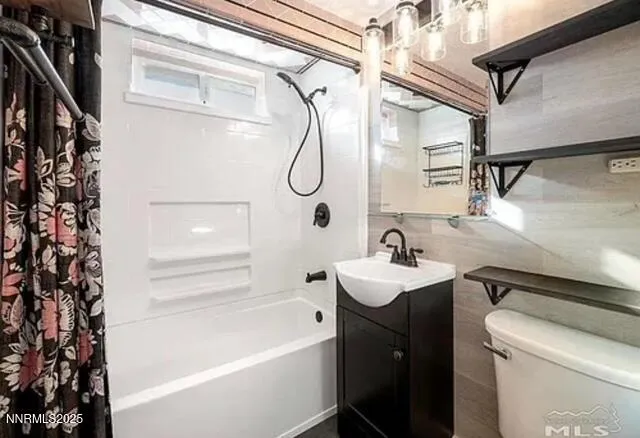 a bathroom with a sink vanity mirror and toilet
