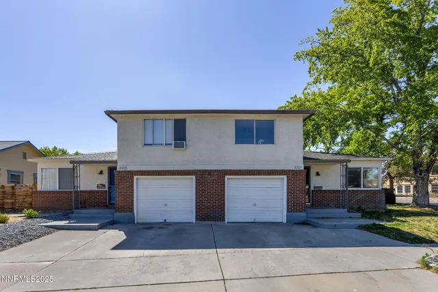 a front view of a house with a garden and garage