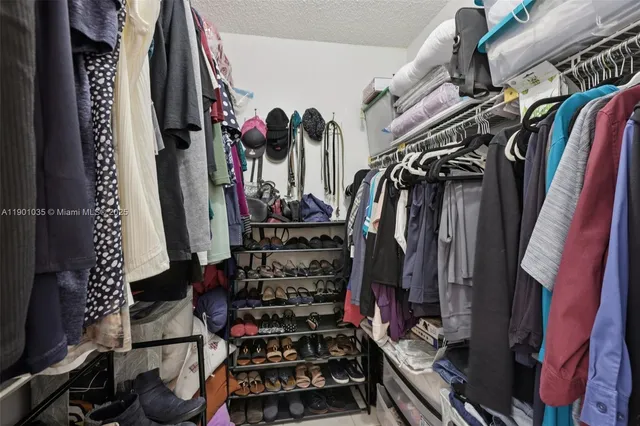 a bedroom with a large bed and flat tv