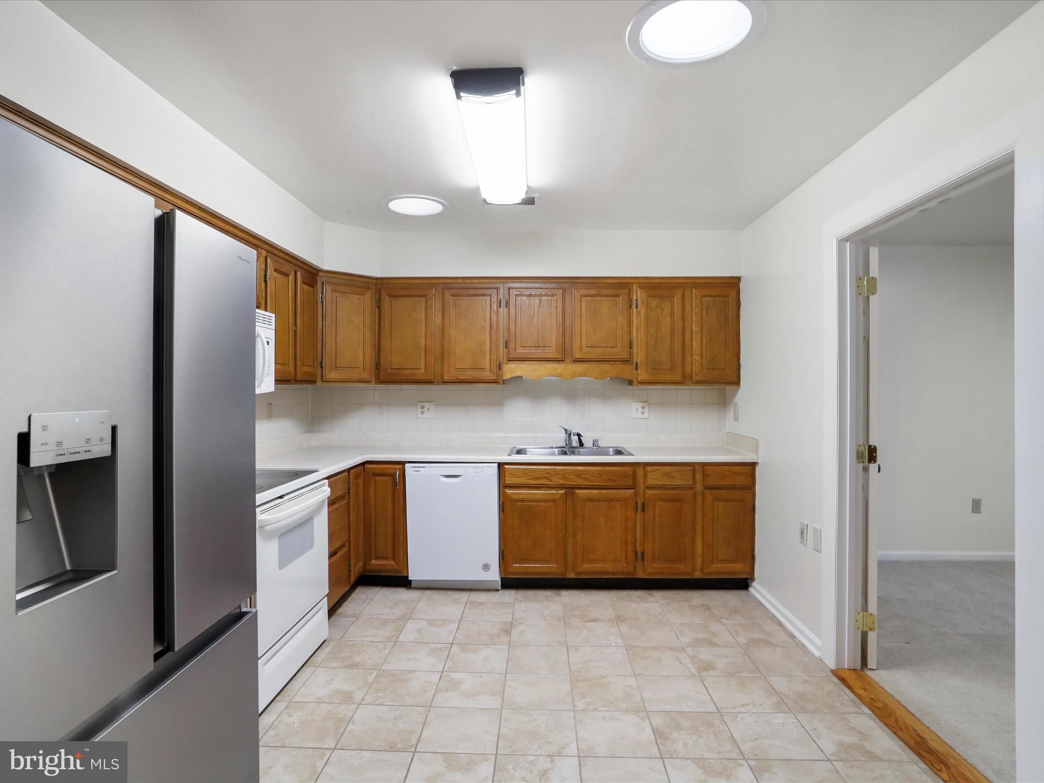 18016 Putter Drive Hagerstown, MD 21740 - Photo 12 of 26 a kitchen with stainless steel appliances granite countertop a refrigerator and a stove top oven