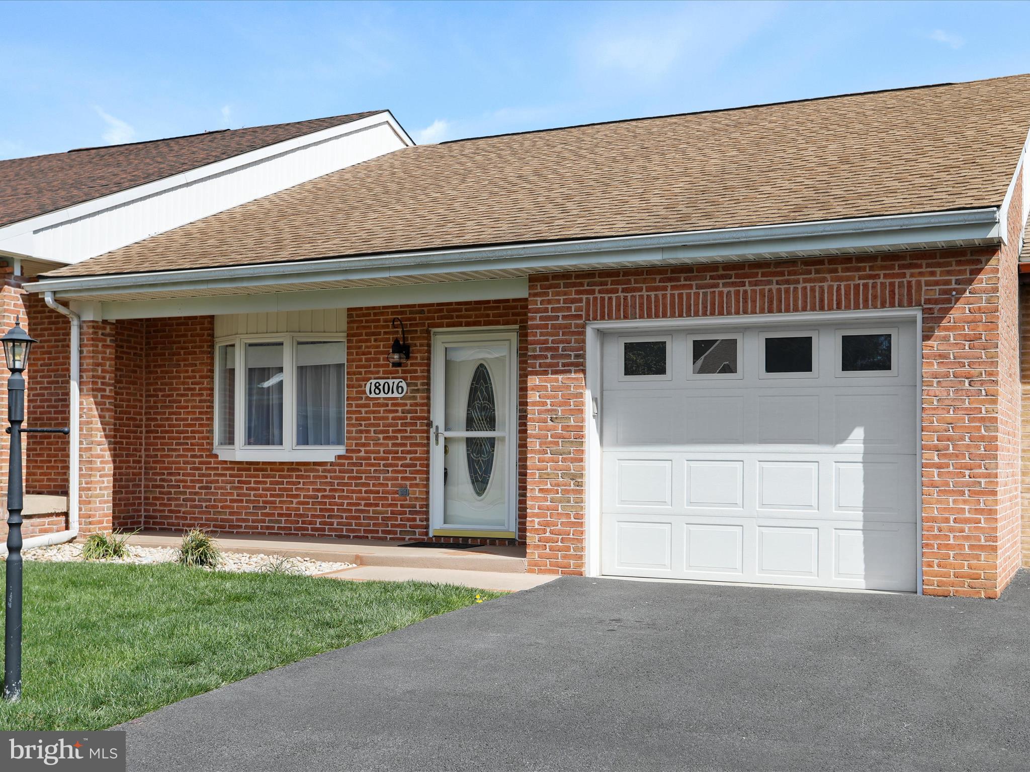 18016 Putter Drive Hagerstown, MD 21740 - Photo 2 of 26 a front view of a house with a yard and garage