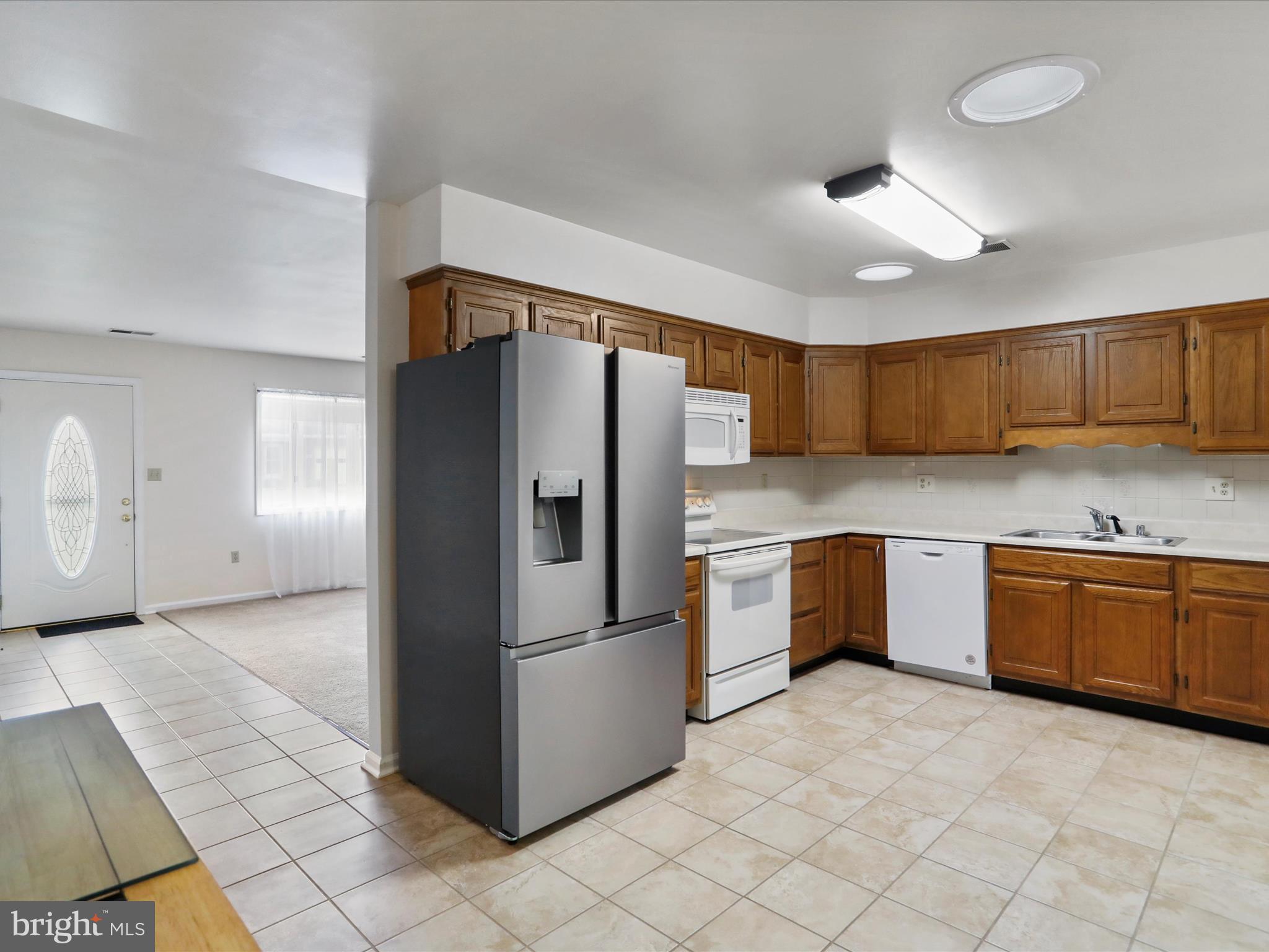 18016 Putter Drive Hagerstown, MD 21740 - Photo 9 of 26 a kitchen with granite countertop a refrigerator and a sink