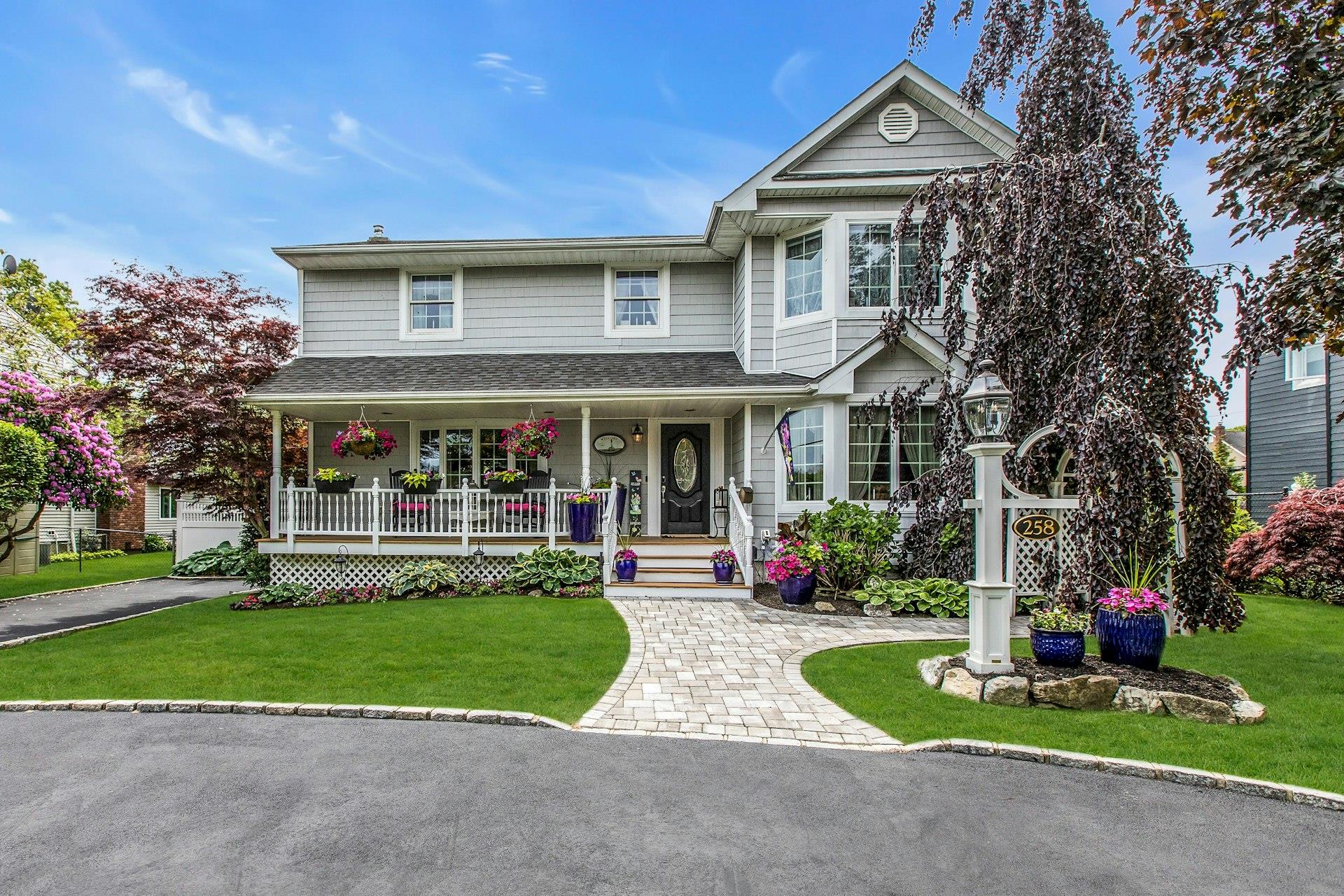 258 Timber Point Road East Islip, NY 11730 - Photo 1 of 1 a front view of a house with a yard and potted plants