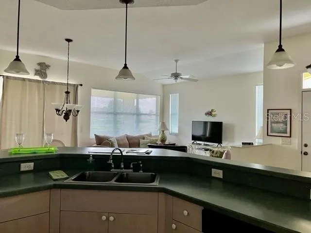 a living room with furniture a flat screen tv and a window