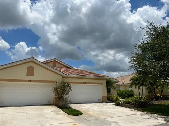 a view of a house with a yard and garage