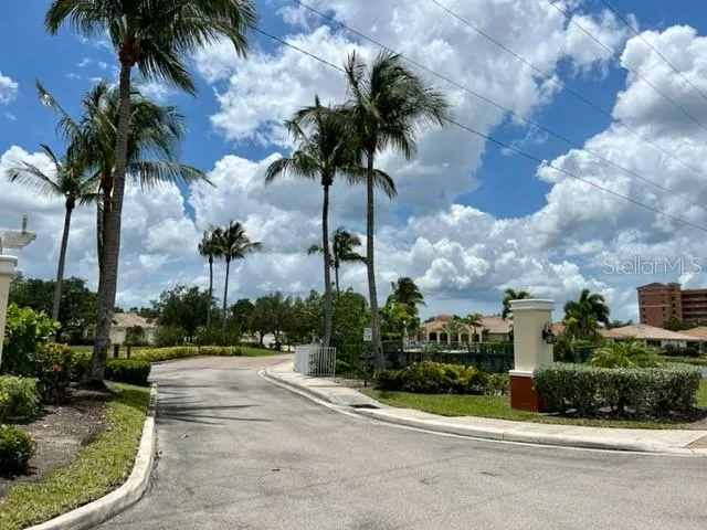 a lake view with a big yard and potted plants