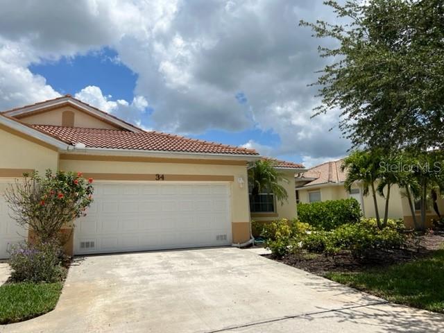 3181 Matecumbe Key Road, Unit 34 Punta Gorda, FL 33955 - Photo 3 of 54 a front view of a house with garden