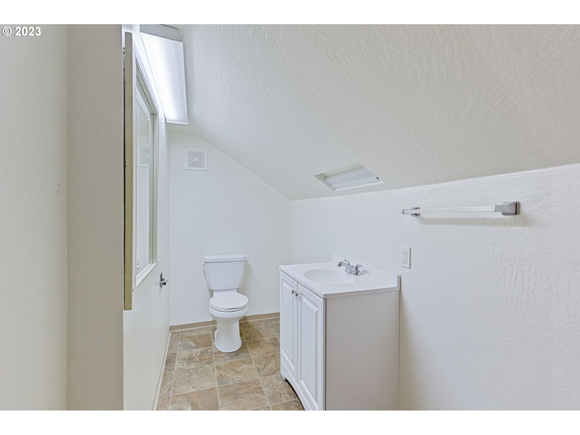 302 Southwest Pine Street Grants Pass, OR 97526 - Photo 18 of 20 a bathroom with a sink a toilet and a mirror