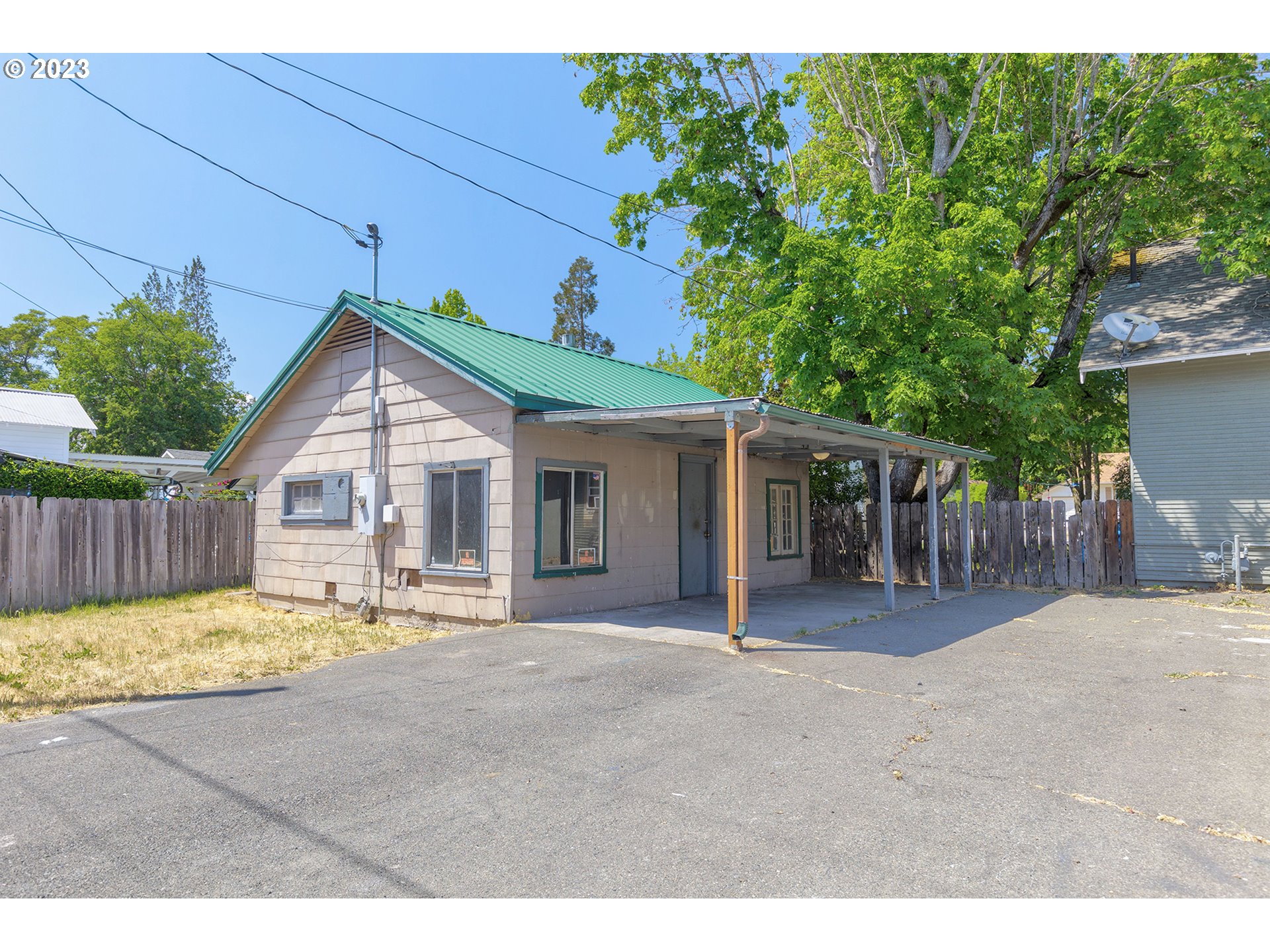 302 Southwest Pine Street Grants Pass, OR 97526 - Photo 9 of 20 a view of a house with a patio and a yard