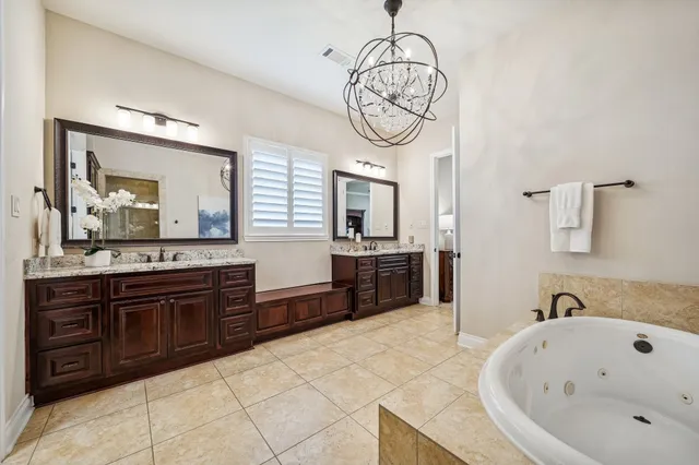 a large bathroom with a large tub and sink