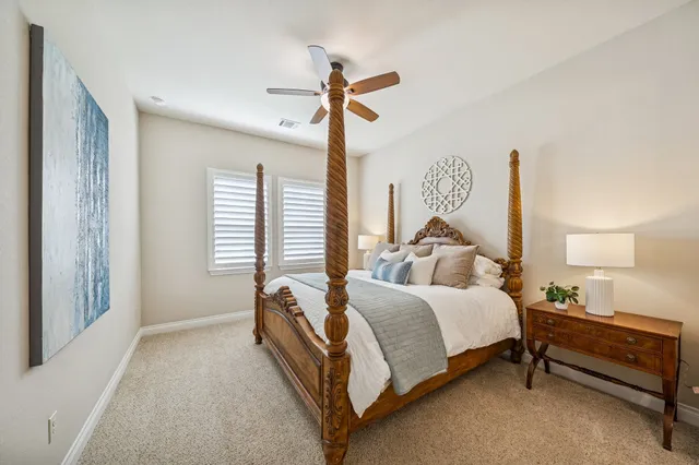 a spacious bedroom with a bed and a chandelier