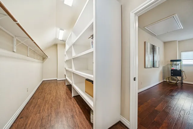 a view of hallway with wooden floor and stairs