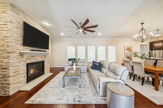 a living room with furniture a fireplace and a flat screen tv