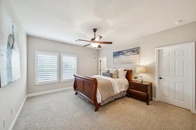 a spacious bedroom with a bed and a chandelier