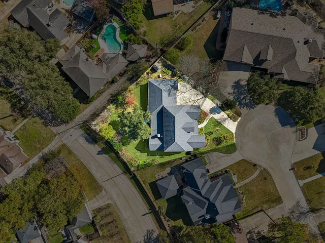 an aerial view of a house with outdoor space
