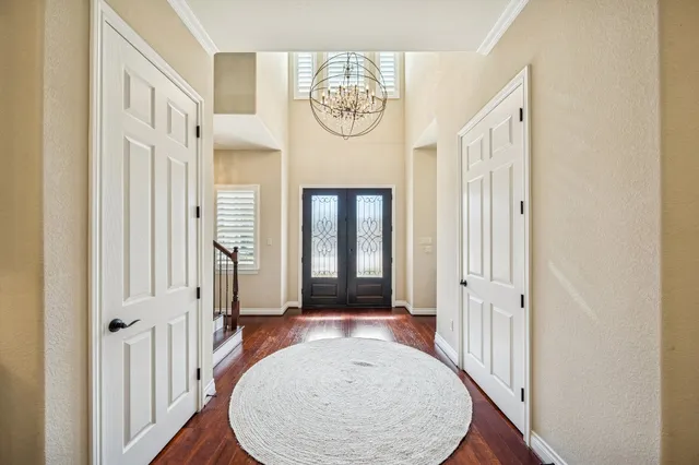 a view of a hallway with wooden floor and dining room