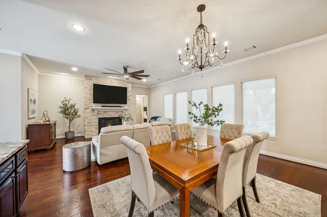 a view of a dining room with furniture a chandelier and wooden floor