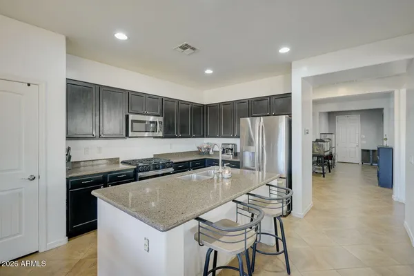 a kitchen with a stove a refrigerator and a dining table
